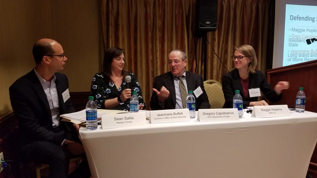 Image of four people speaking on a panel