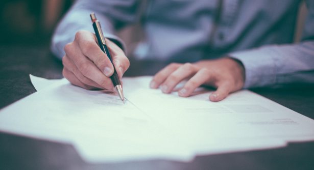 Image of person writing on documents
