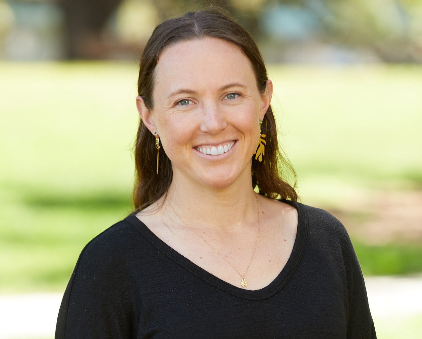 A photo of Vanessa Gerber in a black blouse smiling.