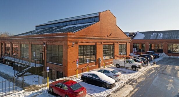 Former factory building made of red brick with large windows and snow in Martinsburg West Virginia