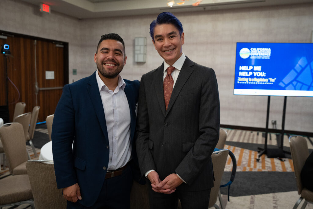 Antonio Lopez and Tyrone Jue in front of CALRC slide at the 2026 California Land Recycling Conference